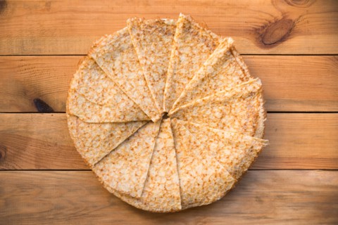 Top view of crepes (french pancakes) folded in circle, on rustic wood background