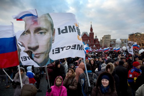 People at the rally-concert "We are together" in support of the annexation of Crimea and Sevastopol to Russia on Red square of Moscow on March 18,2014