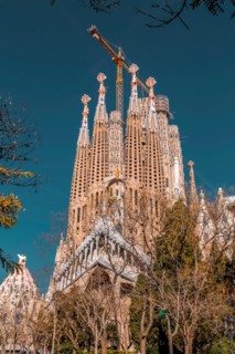 Barcelona, Spain - February 9, 2022: Exterior view of La Sagrada Familia, a large unfinished minor basilica in the Eixample district of Barcelona, Cat