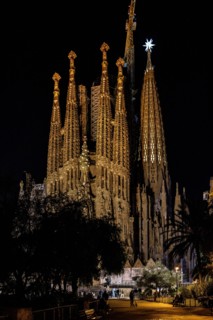 Façana del Naixement (Facade of the Birth) and the star of the Mary tower illuminated at night in the Sagrada Familia (Barcelona, Catalonia, Spain)