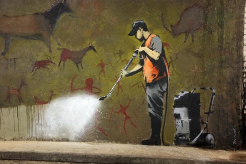 Banksy ironic jet wash cave painting at the Cans Festival, Waterloo, London. Banksy is a pseudonymous street artist and political activist