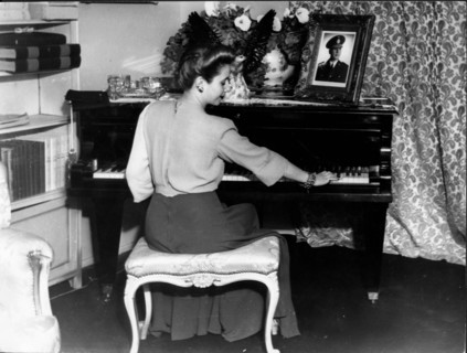 Eva Peron plays the piano at home