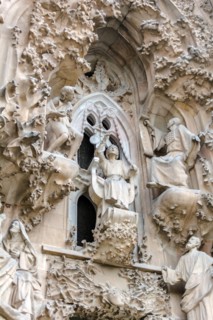 Sagrada Familia exterior, Nativity Facade, The Faith Portico, The finding in the Temple scene. Young Jesus is speaking wisely with the priests of the