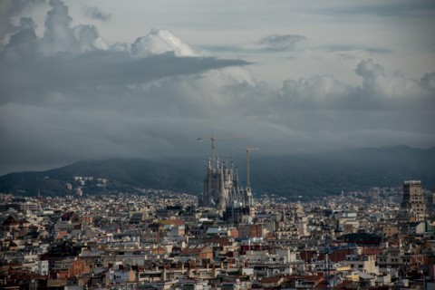 General view of Barcelona city with the Sagrada Familia emerging between the buildings.