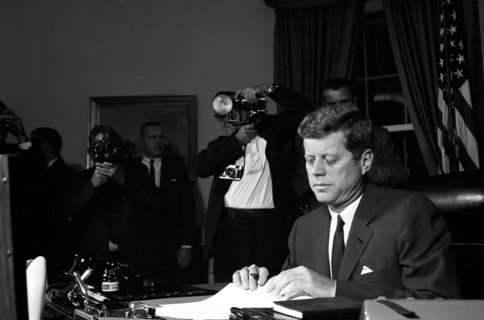 23 October 1962
Proclamation signing, Interdiction of the Delivery of Offensive Missiles to Cuba, 7:05PM.
[White spotting throughout negative.]

Please credit "Cecil Stoughton. White House Photographs...