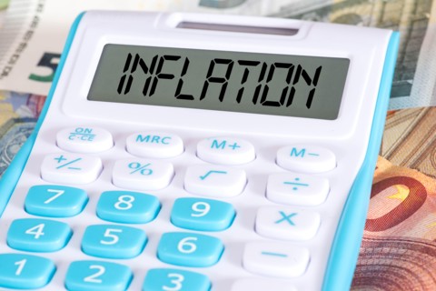 Calculator, euro banknotes and inflation in Europe