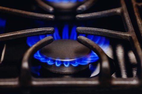 Close-up shot of gas flames burning from a kitchen stove. Natural gas, energetic crisis