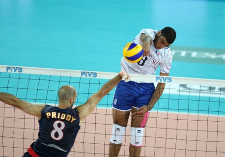 Ngapeth Earvin of France (R) spikes the ball while Priddy William of USA tries to block during the match USA v France