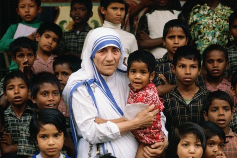 Mother Teresa accompanied by children at her mission in Calcutta, India