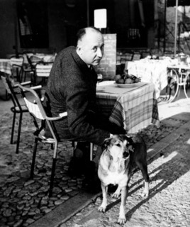 Fashion designer Christian Dior at a cafe with his dog