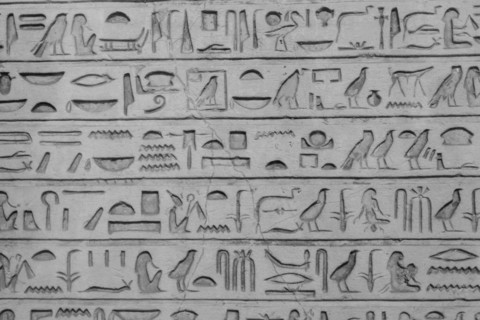 Old egyptians hieroglyphs carved on the stone