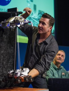 Adam Steltzner, Mars Science Laboratory (MSL) entry, descent and landing phase lead, Jet Propulsion Laboratory, demonstrates how the MSL spacecraft will land the Curiosity rover on Mars during a brief...