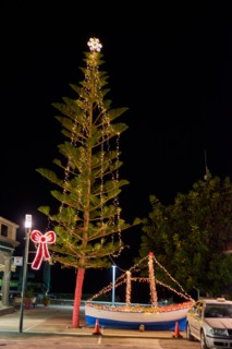Wooden Christmas ship decorated at night. In the Greek tradition (especially in the islands) it is common to ornament a ship instead of a tree.