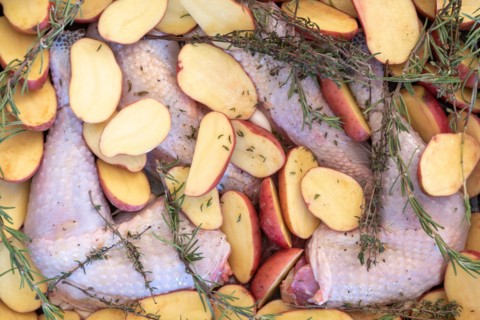 Food, preparation, black chicken, halved potatoes, rosemary, Christmas dinner.