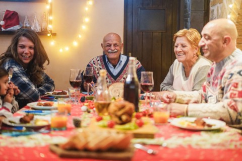 Happy family having Christmas dinner at home - Holiday concept - Focus on grandfather