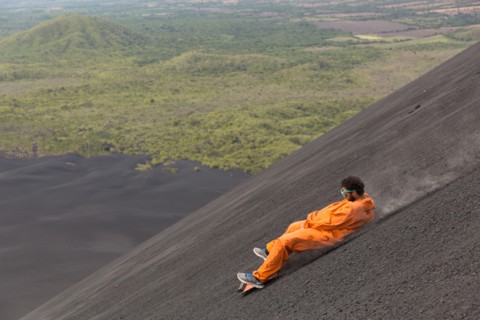 A Volcano surfer slides down Cerro Negro Volcano.