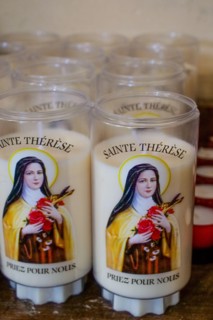 Candles dedicated to Sainte-Therese of Lisieux - close-up view, Saint-Vaast la Hougue church, Saint-Vaast la Hougue, Manche department, Cotentin, Normandy Region, France