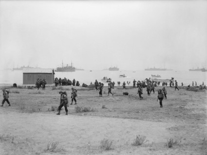 The Royal Navy during the Second World War- Operation Torch, North Africa, November 1942 American troops making their way inland after landing at Arzeu. Several small landing craft can be seen in the ...