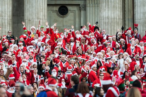London, UK. 14th December, 2013.  Hundreds of Santas gathering on the steps of St Pauls Cathedral before they march off to meet up with groups of other Santas to celebrate the annual Santacon.  Photog...