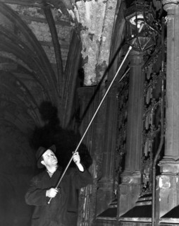 The lamplighter, Mr G Allwn who is employed by the Gas, Light and Coke company and has put on the lights in the Temple for the past 28 years Circa 1950