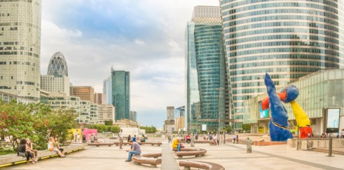 people relaxing on the promenade of la defense