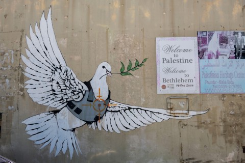Famous Graffiti by renowned artist Banksy titled 'Armored Dove'  in Bethlehem, Palestine, West Bank