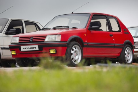 Cobreces, Spain - August 14, 2021: Car show in Cobreces. Original red Peugeot 205 GTI. The Peugeot 205 is a car produced by the French manufacturer Pe