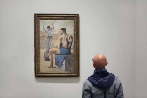 Visitor in front of the painting 'Young Acrobat on a Ball' by Pablo Picasso (1905) displayed at the exhibition 'Icons of Modern Art from the Morozov Collection' in the Fondation Louis Vuitton in Paris...