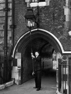 The lamplighter, Mr G Allwn who is employed by the Gas, Light and Coke company and has put on the lights in the Temple for the past 28 years Circa 1950
