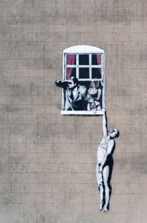 The infamous work by Banksy known as Well Hung Lover, Naked Man Hanging From Window, or just Naked Man. This piece is viewed from Park Street, Bristol.