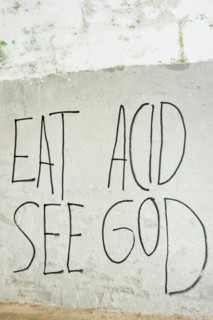 text-graffito saying "eat acid, see god" ,
