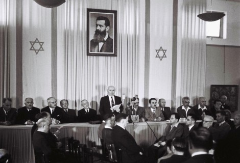 David Ben Gurion, who was to become Israel's first Prime Minister, reads the Israeli Declaration of Independence May 14, 1948 at the museum in Tel Aviv, during the ceremony founding the State of Israe...