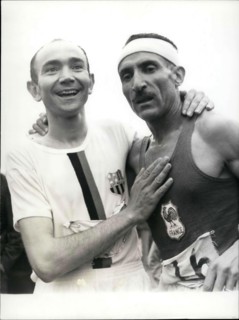 Jun. 26, 1966 - Alain Mimoun, who won the 10,000 M race in Paris a week ago, surprised us again by winning the Marathon in front of Combes at 46 years-old. Picture: After his victory, Combes congratul...
