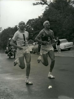 Jun. 26, 1966 - Alain Mimoun, who won the Paris's 10,000 meter race a week ago, surprised us again by winning the Marathon in front of Combes at the age of 46. Combes and Mimoun are pictured running t...