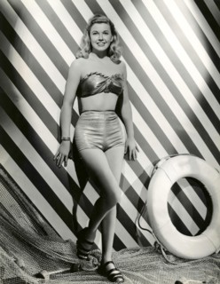 A model wears a swimsuit two-piece 40s