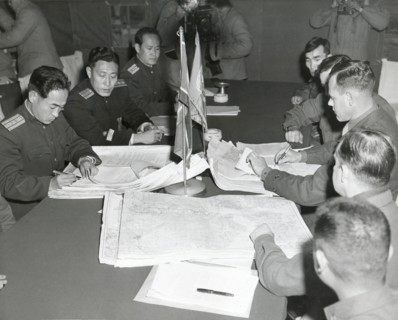 Panmunjom, Korea - Col. James C. Murray, Jr., USMC (rt) and Col Chang Chun San, of the North Korean Communist Army (left) initial maps showing the North and South boundaries of the Demarcation Zone, d...