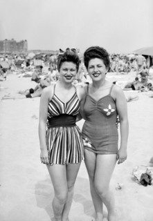 Sisters pose together on the beach in fashionable swimwear, ca. 1946.