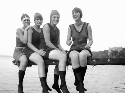 A group of young women happily pose on a diving board overlooking Lake Mendota in Madison, Wisconsin.
