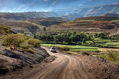 ETHIOPIA, LALIBELA, 4 wheel drive car on its way through a spectecular mountain scenery on a gravel road between  Mekelle and Lalibela