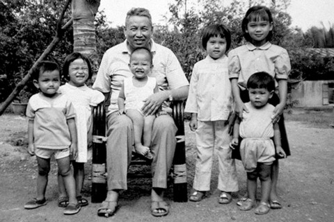 Cambodia: Khmer Rouge leader Saloth Sar, aka Pol Pot, sitting with group of children at Anlong Veng,  c. 1990. The child on his lap is probably Pol Pot's daughter. Others may be his grandchildren, or ...