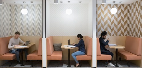 Workflow in modern coworking space of three diverse businesspeople
