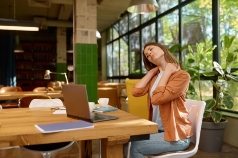 Tired young business woman working at coworking space