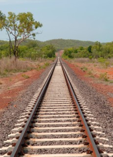 Straight railway track on the Alice Springs to Katherine Rail line carrying The Ghan,