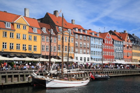 Tourists and colourful houses at Nyhavn, Copenhagen, Denmark