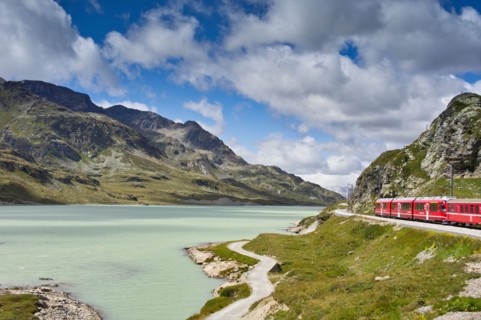 The Glacier Express train winds its way around the rocky mountain lakes of Switzerland