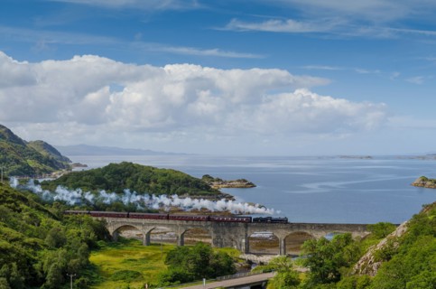 the jacobite steam train crossing the glen mama viaduct