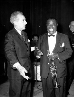Jean Cocteau talking with a musician