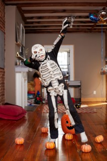 Black boy wearing skeleton Halloween costume