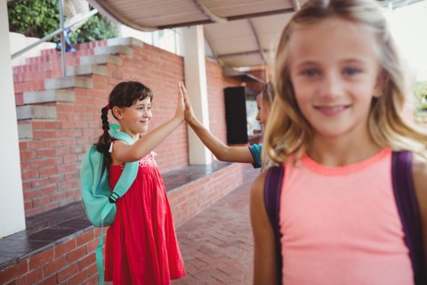 Three happy kids at school