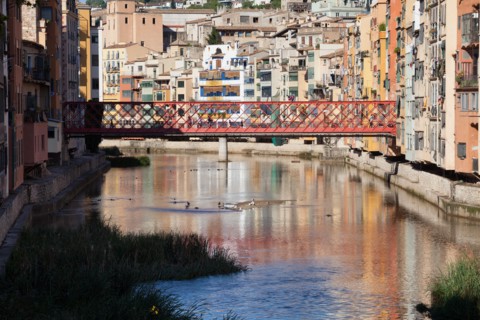 Historic houses and the Eiffel Bridge over the Onyar River in Girona, Catalonia, Spain